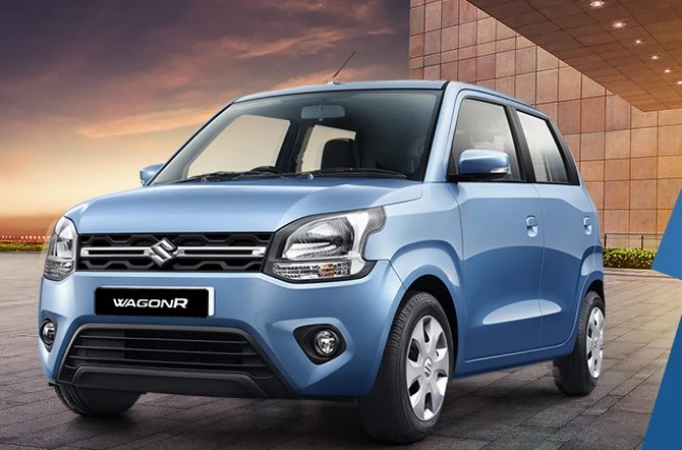 2025 Maruti Wagon R parked in a modern urban setting, featuring a bold dual-tone colour scheme and upright tall-boy design, showcasing the refreshed exterior look